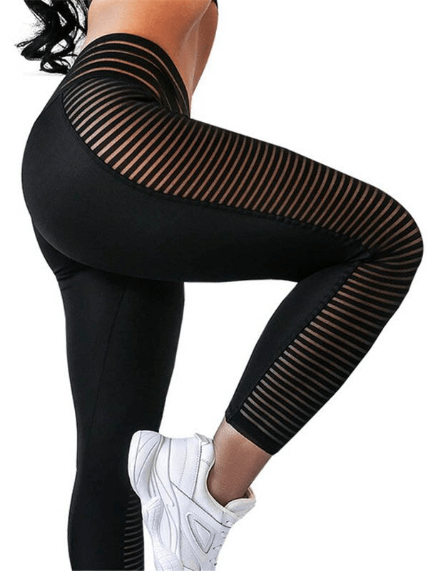 Woman wearing black mesh patchwork high waist leggings and white sneakers, striking a pose for an active, stylish look.